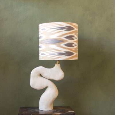 Organic formed table lamp in ceramics with Ikat lampshade.