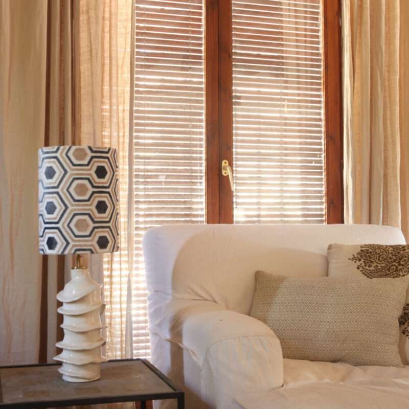 Smile ceramic lamp near armchair